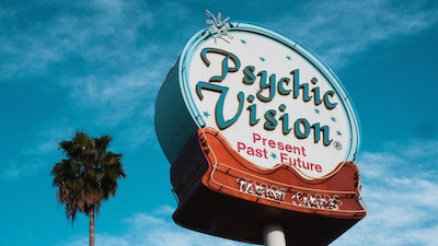 A 1960's era sign that says "Psychic Visions"