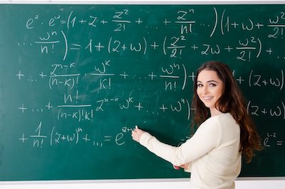 Woman doing math at a chalkboard.